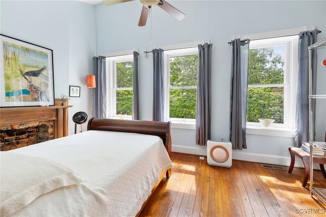 116 N 29th St, Richmond, VA 23223 - bedroom featuring a fireplace, visible vents, wood-type flooring, and baseboards
