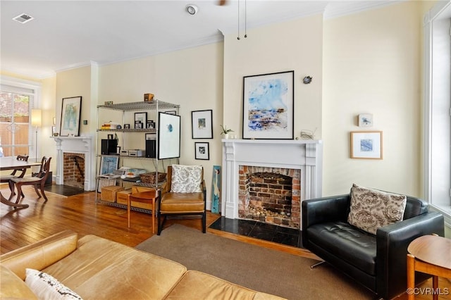 116 N 29th St, Richmond, VA 23223 - living area featuring visible vents, ornamental molding, wood finished floors, and a brick fireplace