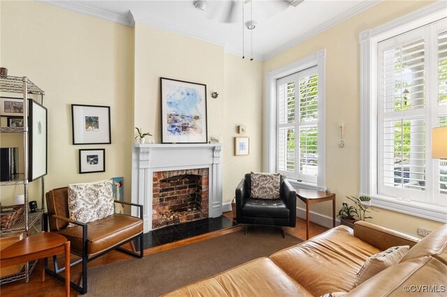 116 N 29th St, Richmond, VA 23223 - living area featuring a fireplace, wood finished floors, a ceiling fan, and ornamental molding