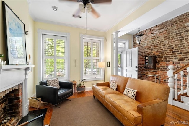 116 N 29th St, Richmond, VA 23223 - living area with stairway, a brick fireplace, a ceiling fan, visible vents, and wood finished floors