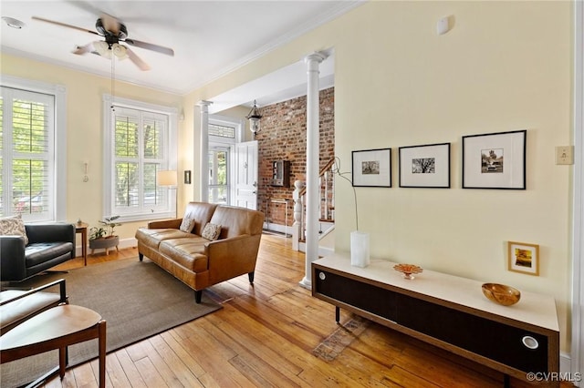 116 N 29th St, Richmond, VA 23223 - living area with a healthy amount of sunlight, crown molding, light wood-style flooring, and decorative columns