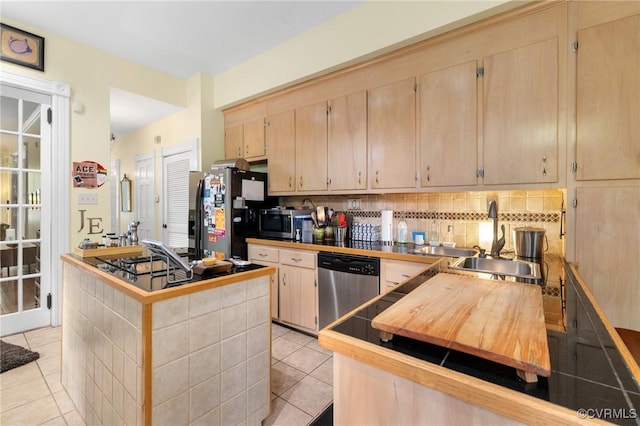 116 N 29th St, Richmond, VA 23223 - kitchen with light tile patterned floors, decorative backsplash, a sink, stainless steel appliances, and light brown cabinetry