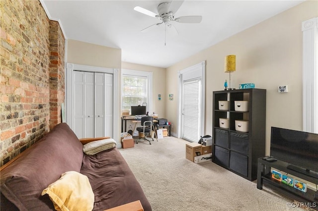 116 N 29th St, Richmond, VA 23223 - living area featuring ceiling fan, brick wall, and carpet flooring