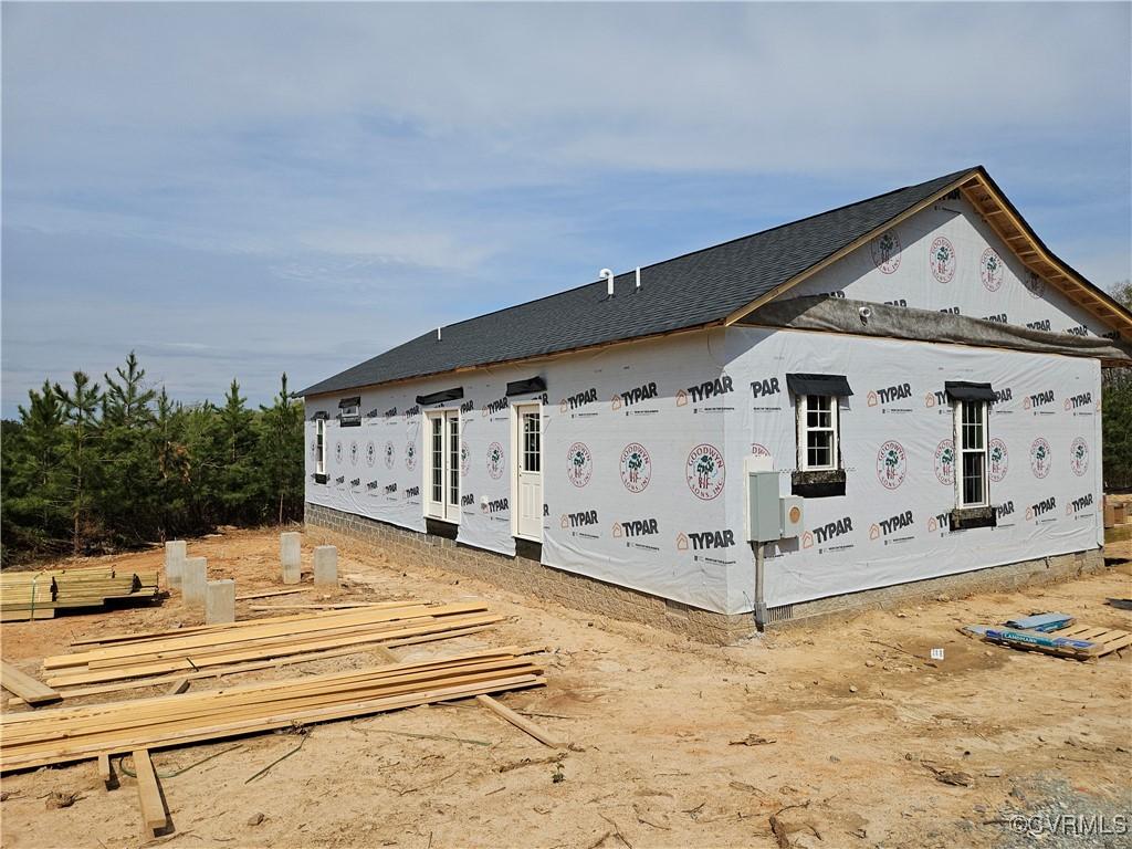 view of home's exterior with roof with shingles