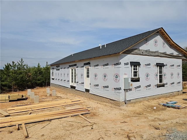 view of home's exterior with roof with shingles
