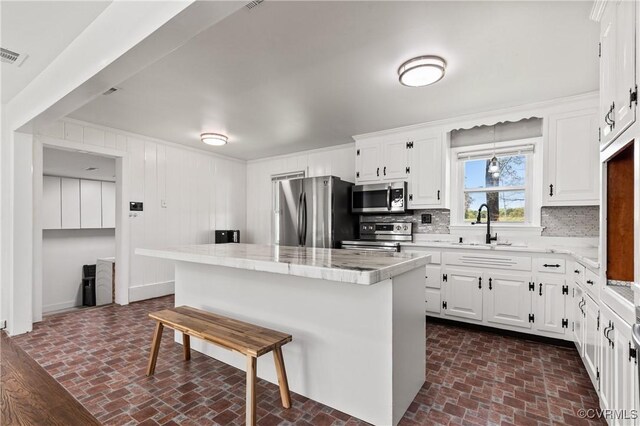 2230 Lancers Blvd, Chesterfield, VA 23224 - kitchen featuring appliances with stainless steel finishes, brick patterned floors, a sink, and backsplash