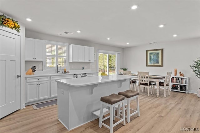 8106 W Danube Loop, New Kent, VA 23124 - kitchen with a sink, stainless steel dishwasher, light countertops, white cabinets, and recessed lighting