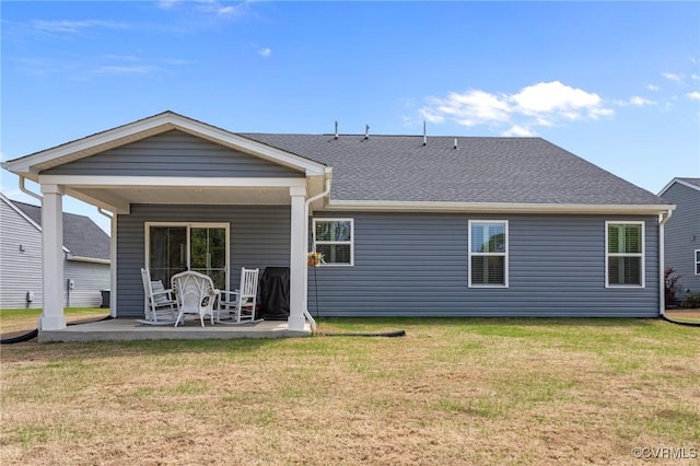8106 W Danube Loop, New Kent, VA 23124 - back of property with a lawn, a patio, and roof with shingles