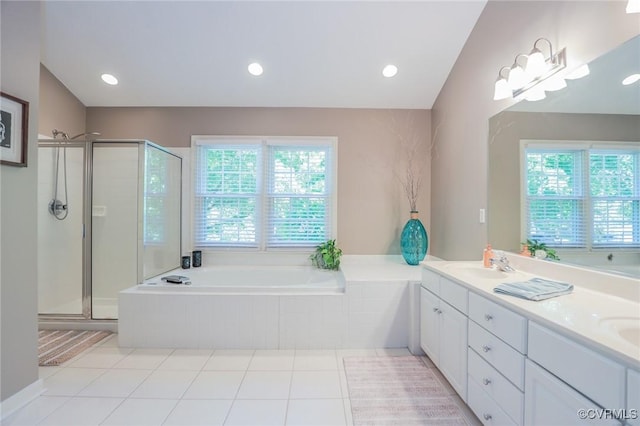 bathroom with a sink, double vanity, a stall shower, and a bath