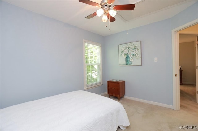 bedroom featuring light colored carpet, attic access, baseboards, and a ceiling fan