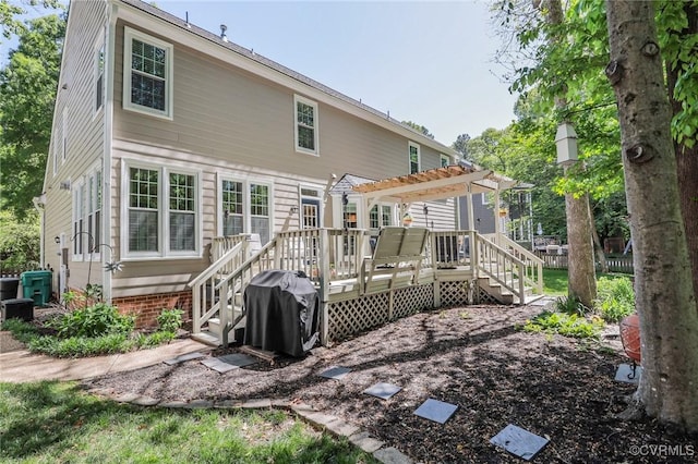 back of property with a pergola and a deck