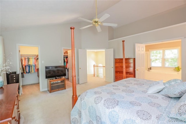 carpeted bedroom with a closet, ceiling fan, a spacious closet, and high vaulted ceiling
