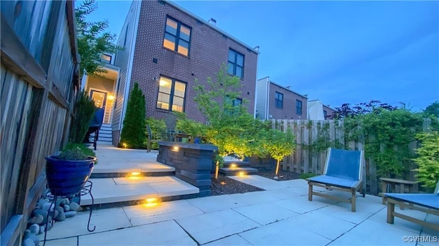 2611 Kensington Ave, Richmond, VA 23220 - rear view of house featuring brick siding, a patio, and fence