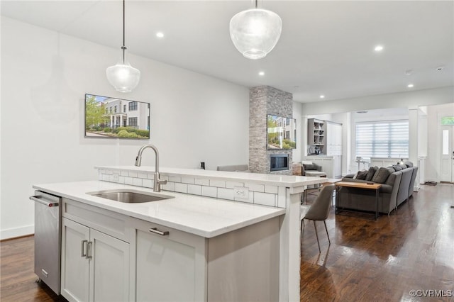 2611 Kensington Ave, Richmond, VA 23220 - kitchen featuring a kitchen island with sink, decorative light fixtures, a sink, and dark wood-style flooring