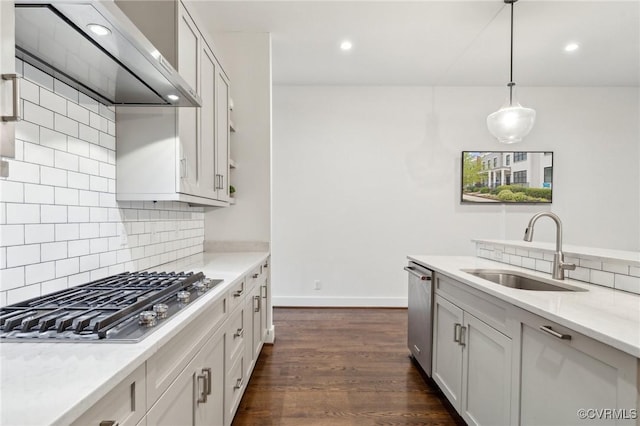 2611 Kensington Ave, Richmond, VA 23220 - kitchen featuring wall chimney range hood, decorative backsplash, appliances with stainless steel finishes, and a sink