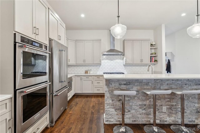 2611 Kensington Ave, Richmond, VA 23220 - kitchen with open shelves, light countertops, backsplash, wall chimney exhaust hood, and appliances with stainless steel finishes
