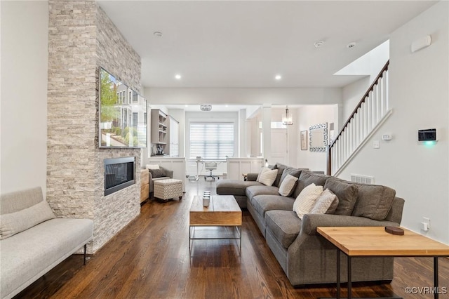 2611 Kensington Ave, Richmond, VA 23220 - living room featuring recessed lighting, stairway, a stone fireplace, visible vents, and dark wood-style flooring