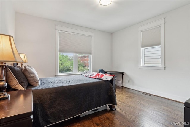 2611 Kensington Ave, Richmond, VA 23220 - bedroom featuring baseboards, dark wood-style flooring, and visible vents