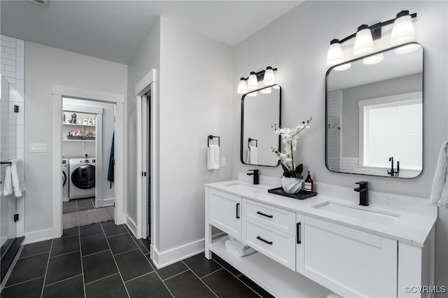 full bathroom with separate washer and dryer, baseboards, tile patterned floors, and a shower with door
