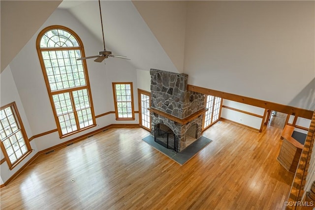328 Perrow Ln, Manakin Sabot, VA 23103 - living room featuring ceiling fan, high vaulted ceiling, a stone fireplace, baseboards, and wood finished floors