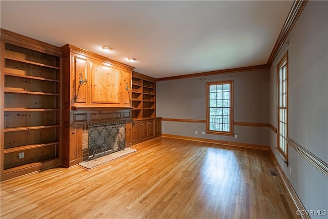 328 Perrow Ln, Manakin Sabot, VA 23103 - unfurnished living room featuring a stone fireplace, crown molding, built in shelves, baseboards, and light wood finished floors