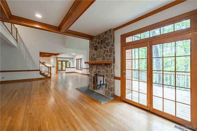 328 Perrow Ln, Manakin Sabot, VA 23103 - unfurnished living room featuring a fireplace, baseboards, wood finished floors, beamed ceiling, and visible vents