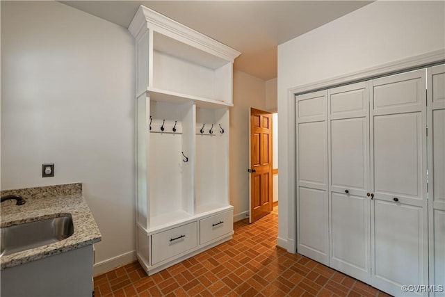328 Perrow Ln, Manakin Sabot, VA 23103 - mudroom with baseboards, brick patterned floor, and a sink