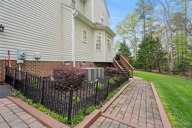 12419 Trumpington Ct, Chesterfield, VA 23838 - view of side of property featuring stairway, fence, cooling unit, and a lawn