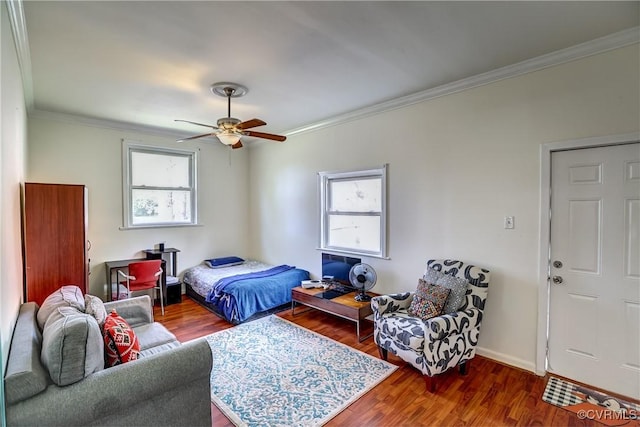 bedroom with ceiling fan, baseboards, ornamental molding, and wood finished floors