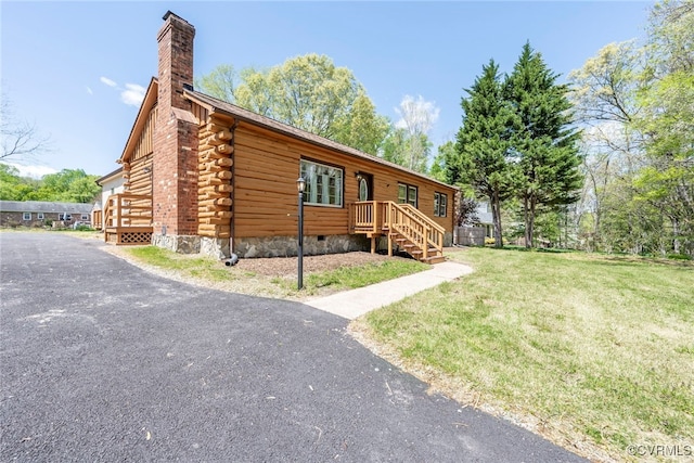 6631 Rural Point Rd, Mechanicsville, VA 23116 - log-style house with log exterior, a chimney, a front lawn, and crawl space