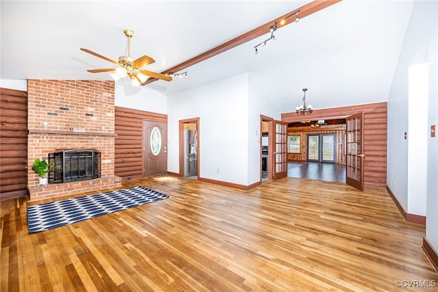 6631 Rural Point Rd, Mechanicsville, VA 23116 - unfurnished living room featuring high vaulted ceiling, rustic walls, ceiling fan, a fireplace, and light wood-style flooring