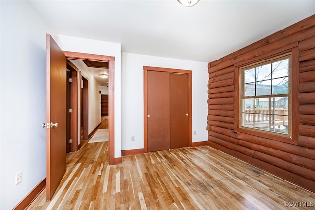 6631 Rural Point Rd, Mechanicsville, VA 23116 - unfurnished bedroom featuring rustic walls, light wood-type flooring, baseboards, a closet, and attic access