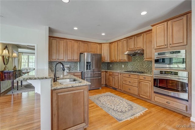 3801 Duckling Walk, Glen Allen, VA 23060 - kitchen featuring stainless steel appliances, a sink, a peninsula, light wood-style floors, and recessed lighting