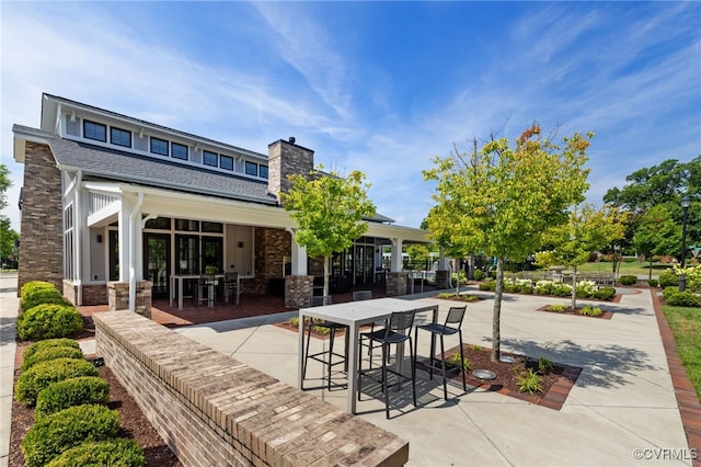 2248 Libbie Lake W Street A, Henrico, VA 23230 - exterior space with a chimney, roof with shingles, a patio area, and outdoor dining area