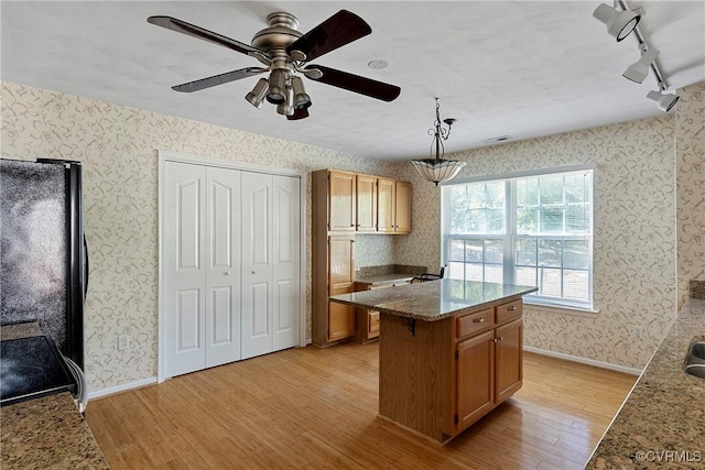 14530 Hancock Ridge Ct, Chesterfield, VA 23832 - kitchen with light wood-type flooring, freestanding refrigerator, rail lighting, wallpapered walls, and a center island