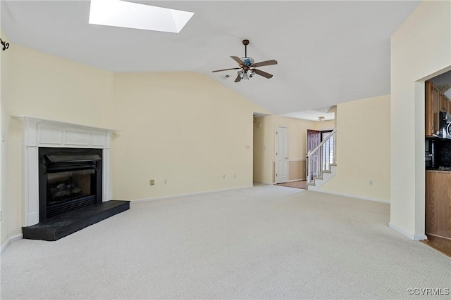 14530 Hancock Ridge Ct, Chesterfield, VA 23832 - unfurnished living room featuring stairway, a skylight, vaulted ceiling, a fireplace with raised hearth, and a ceiling fan