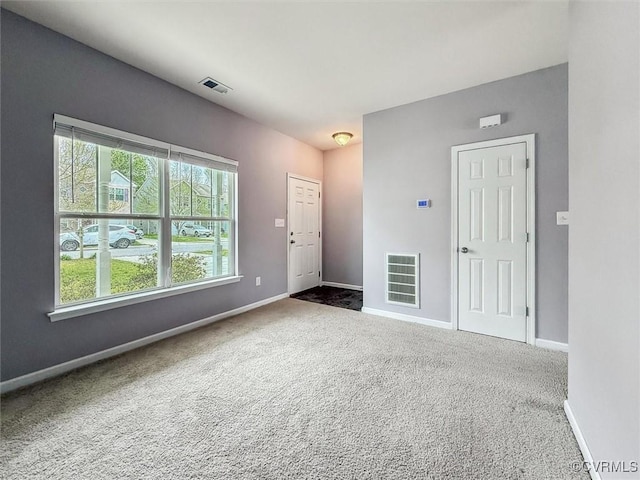 interior space with baseboards and visible vents