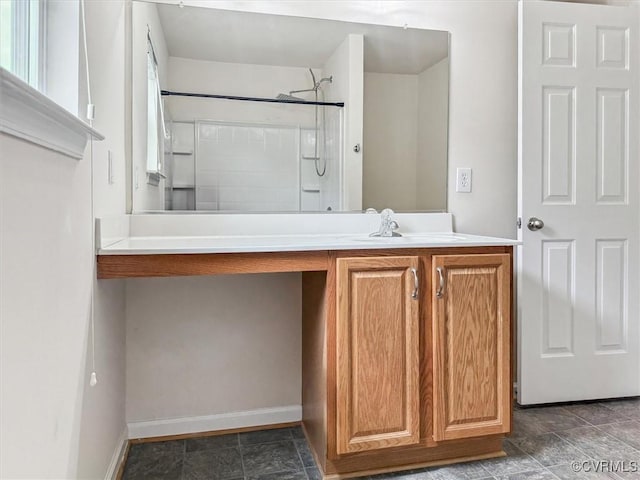 full bathroom featuring baseboards, vanity, and a shower