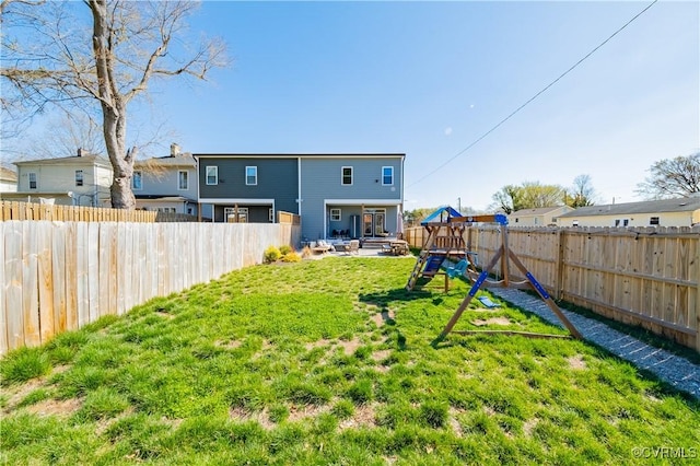 300 W 25th St, Richmond, VA 23225 - back of house featuring a patio area, a fenced backyard, a yard, and a playground