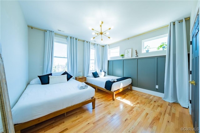 300 W 25th St, Richmond, VA 23225 - bedroom with a chandelier, visible vents, and light wood-type flooring