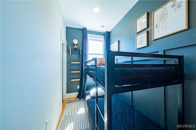 300 W 25th St, Richmond, VA 23225 - bedroom with baseboards, wood finished floors, and visible vents