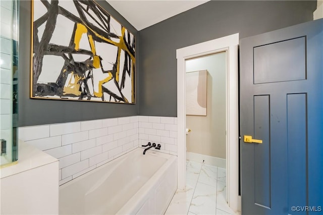 300 W 25th St, Richmond, VA 23225 - bathroom featuring baseboards, a garden tub, and marble finish floor