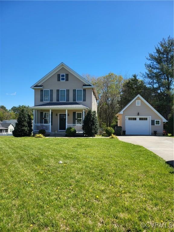 640 Coniston Manor Dr, Gordonsville, VA 22942 - view of front of house with a porch, driveway, a front lawn, and a detached garage
