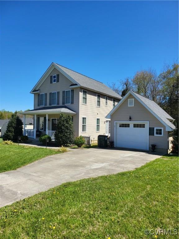 640 Coniston Manor Dr, Gordonsville, VA 22942 - view of front facade with concrete driveway, an outbuilding, a porch, a front yard, and a garage