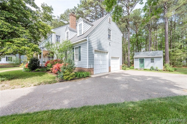 3112 Brookemoor Ct, Glen Allen, VA 23060 - view of side of property featuring a chimney, a yard, an attached garage, driveway, and an outbuilding