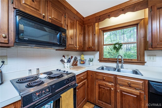 3112 Brookemoor Ct, Glen Allen, VA 23060 - kitchen featuring a sink, decorative backsplash, brown cabinetry, light countertops, and black appliances