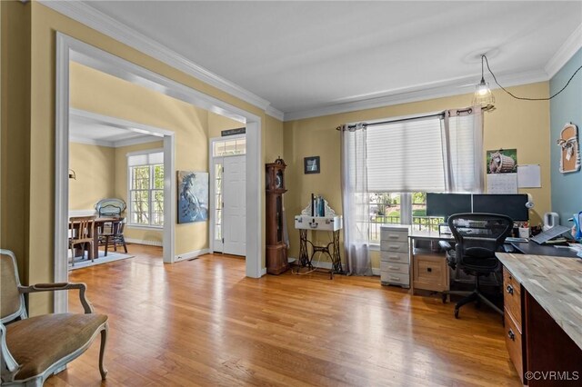 office area with crown molding, baseboards, and light wood-style flooring