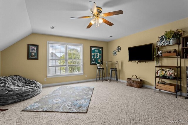 living room featuring carpet flooring, ceiling fan, visible vents, and lofted ceiling