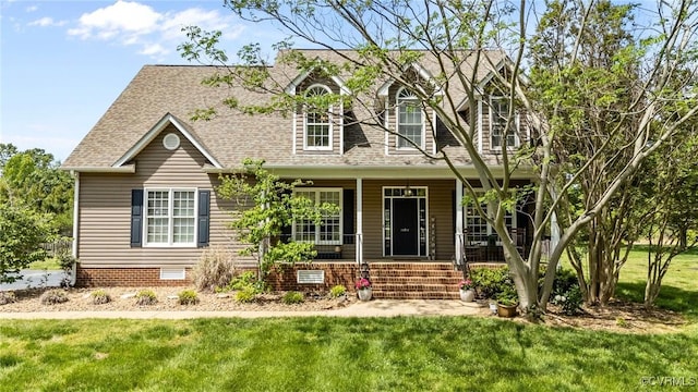 new england style home featuring covered porch, crawl space, a front yard, and roof with shingles