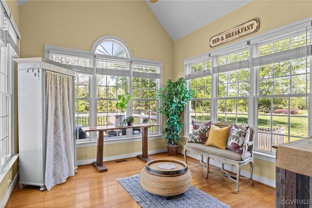 sunroom / solarium with a healthy amount of sunlight, french doors, and wood finished floors